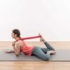 Woman doing a stretching exercise with red exercise loop from Liebscher and Bracht